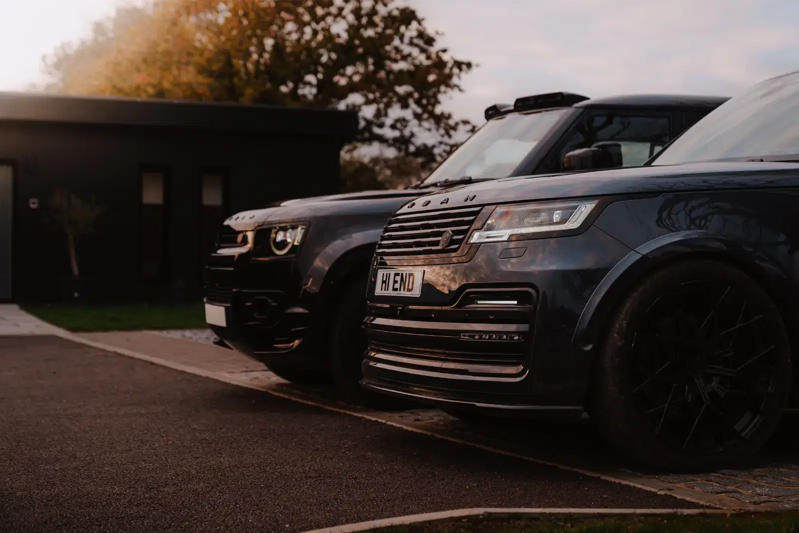 Two luxury cars parked together.